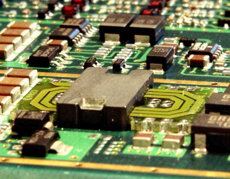 Photograph of a planar DC/DC converter module rated for 150 W output power with 94% efficiency, showing the flat profile and surface-mount construction